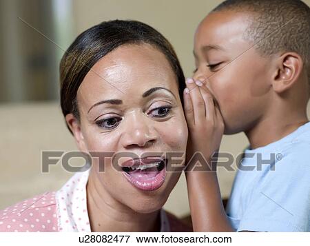 Close up of boy whispering to mother View Large Photo Image Stock Photo - Close up of boy whispering to mother. Fotosearch