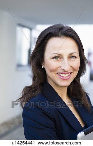 Stock Image - Close up of businesswomans smiling face. Fotosearch