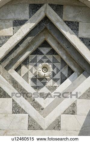 Stock Photography - Close up of carved flower on ornate wall. Fotosearch