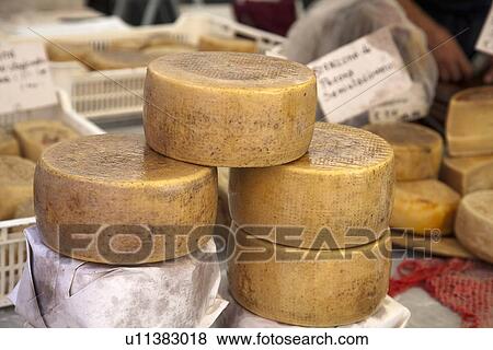 Stock Photo - Close up of cheese wheels for sale. Fotosearch