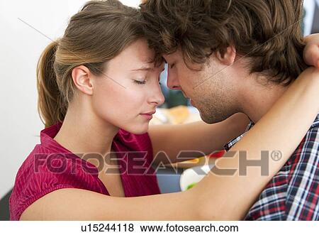 Stock Photo - Close up of couple hugging. Fotosearch