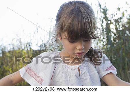 Close up of girl standing outdoors View Large Photo Image Stock Photo - Close up of girl standing outdoors. Fotosearch