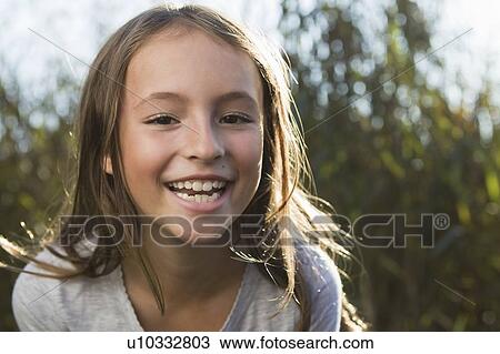 Close up of girls smiling face View Large Photo Image Stock Image - Close up of girls smiling face. Fotosearch