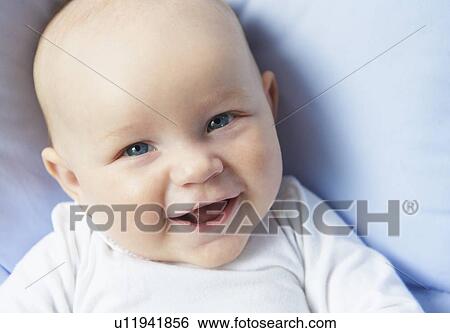 Stock Photograph - Close up of infants laughing face. Fotosearch