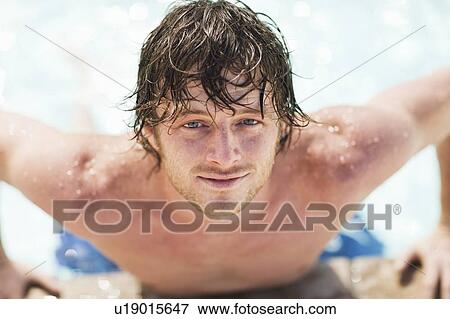 Close up of man climbing out of pool View Large Photo Image Stock Photo - Close up of man climbing out of pool. Fotosearch
