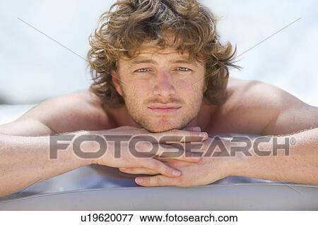 Stock Photo - Close up of man resting chin on hands. Fotosearch