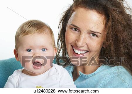 Close up of mother holding infant View Large Photo Image Stock Photo - Close up of mother holding infant. Fotosearch