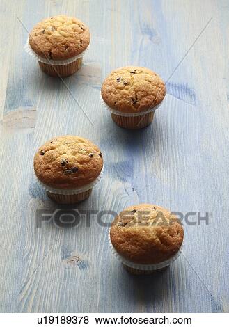 Stock Photo - Close up of muffins on wooden table. Fotosearch