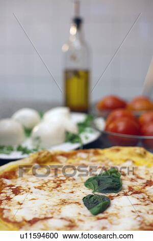 Close up of pizza with basil leaves View Large Photo Image Stock Image - Close up of pizza with basil leaves. Fotosearch