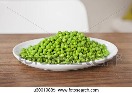 Stock Photography - Close up of plate of peas on table. Fotosearch