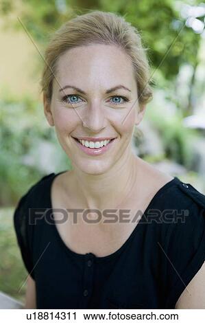 Stock Image - Close up of smiling womans face. Fotosearch