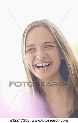 Stock Photo - Close up of teenage girl in braces. Fotosearch