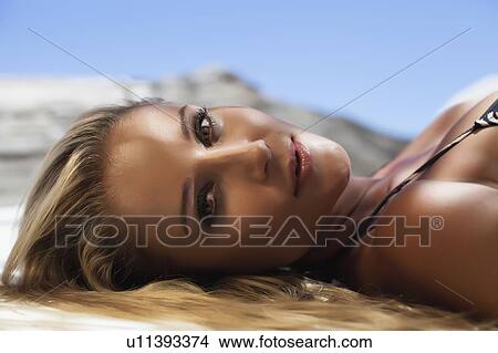 Close up of woman laying on towel View Large Photo Image Picture - Close up of woman laying on towel. Fotosearch