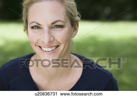 Stock Image - Close up of womans smiling face. Fotosearch
