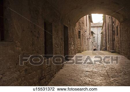 Stock Image - Cobbled archway in village. Fotosearch