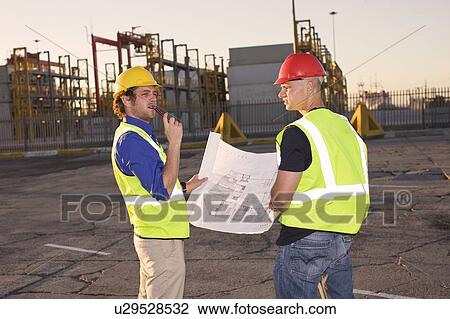 Construction workers reading blueprint View Large Photo Image Stock Image - Construction workers reading blueprint. Fotosearch