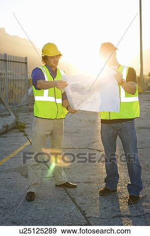 Construction workers reading blueprint View Large Photo Image Stock Photo - Construction workers reading blueprint. Fotosearch