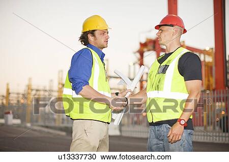 Construction workers talking on site View Large Photo Image Stock Image - Construction workers talking on site. Fotosearch