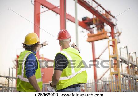 Construction workers talking on site View Large Photo Image Stock Image - Construction workers talking on site. Fotosearch