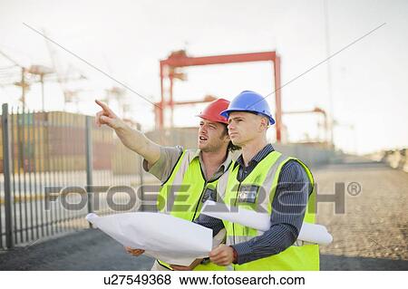 Stock Photo - Construction workers talking on site. Fotosearch