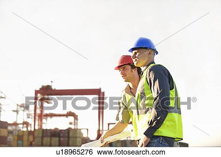 Construction workers talking on site View Large Photo Image Stock Photograph - Construction workers talking on site. Fotosearch
