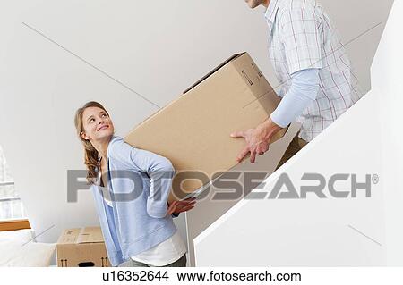 Picture - Couple carrying cardboard box. Fotosearch