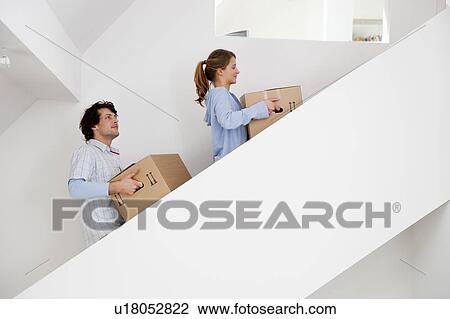 Couple carrying cardboard boxes View Large Photo Image Stock Image - Couple carrying cardboard boxes. Fotosearch
