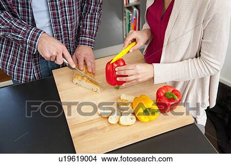 Couple chopping food in kitchen View Large Photo Image Picture - Couple chopping food in kitchen. Fotosearch