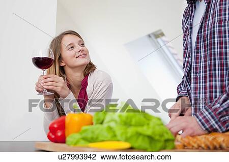 Couple cooking together in kitchen View Large Photo Image Stock Image - Couple cooking together in kitchen. Fotosearch