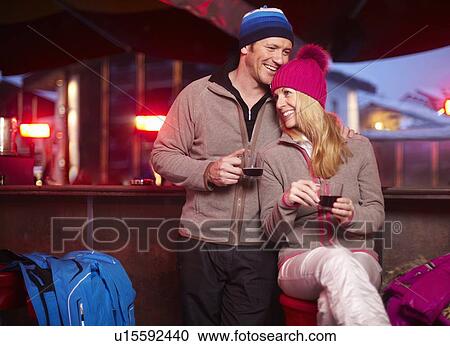 Stock Image - Couple having coffee together at cafe. Fotosearch