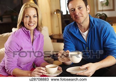 Couple having cup of coffee together View Large Photo Image Stock Image - Couple having cup of coffee together. Fotosearch