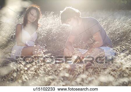 Couple picnicking in wheatfield View Large Photo Image Stock Image - Couple picnicking in wheatfield. Fotosearch