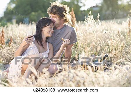 Couple picnicking in wheatfield View Large Photo Image Stock Photo - Couple picnicking in wheatfield. Fotosearch