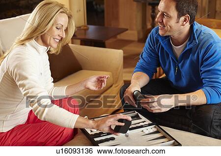 Couple playing backgammon together View Large Photo Image Stock Photograph - Couple playing backgammon together. Fotosearch