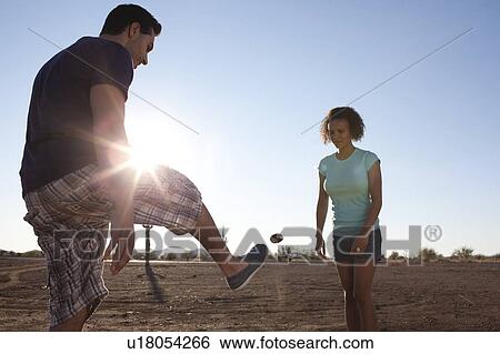Couple playing with hackey sack outdoors View Large Photo Image Stock Photograph - Couple playing with hackey sack outdoors. Fotosearch