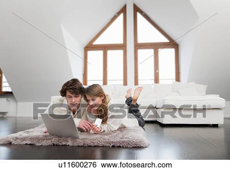 Stock Photograph - Couple shopping online together. Fotosearch