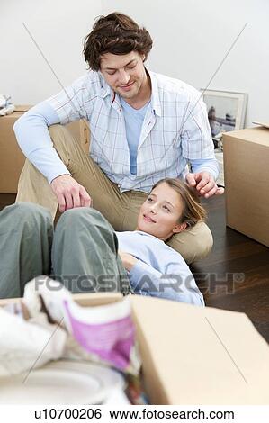 Couple sitting on floor with boxes View Large Photo Image Stock Photograph - Couple sitting on floor with boxes. Fotosearch