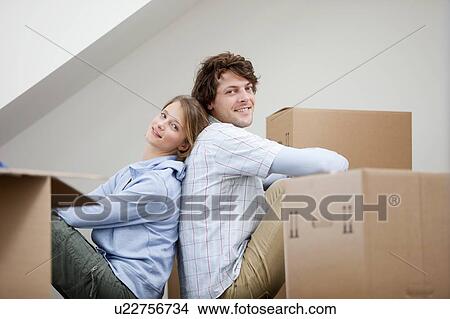 Couple sitting with cardboard boxes View Large Photo Image Picture - Couple sitting with cardboard boxes. Fotosearch