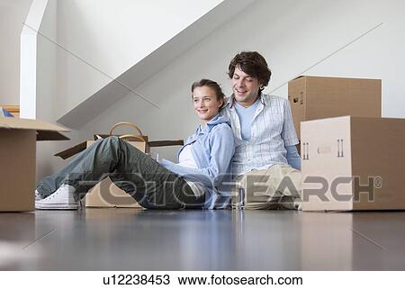Couple sitting with cardboard boxes View Large Photo Image Stock Image - Couple sitting with cardboard boxes. Fotosearch