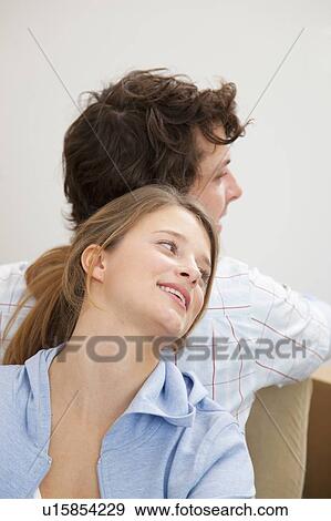 Couple standing back-to-back View Large Photo Image Stock Photo - Couple standing back-to-back. Fotosearch