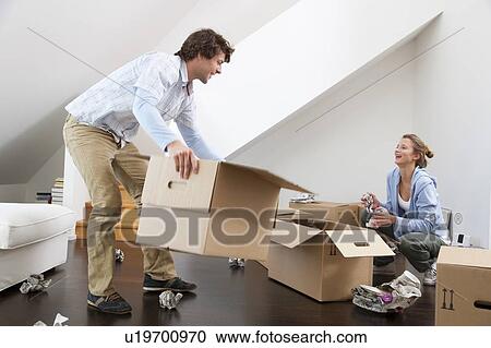 Couple unpacking cardboard boxes View Large Photo Image Stock Image - Couple unpacking cardboard boxes. Fotosearch