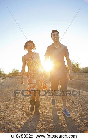 Couple walking together in desert View Large Photo Image Stock Photography - Couple walking together in desert. Fotosearch
