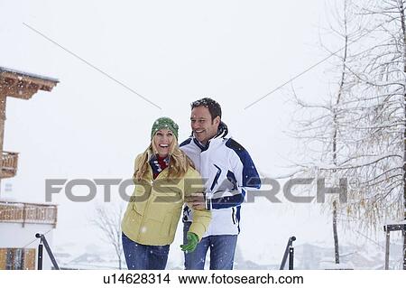 Picture - Couple walking together in snow. Fotosearch