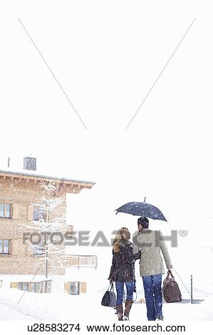 Couple walking together in snow View Large Photo Image Picture - Couple walking together in snow. Fotosearch