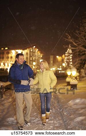 Couple walking together in snow View Large Photo Image Stock Image - Couple walking together in snow. Fotosearch