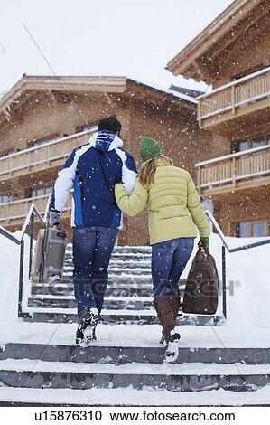 Stock Image - Couple walking together in snow. Fotosearch