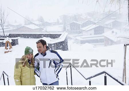 Couple walking together in snow View Large Photo Image Stock Image - Couple walking together in snow. Fotosearch