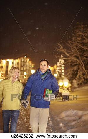 Couple walking together in snow View Large Photo Image Stock Image - Couple walking together in snow. Fotosearch