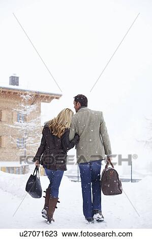 Couple walking together in snow View Large Photo Image Stock Image - Couple walking together in snow. Fotosearch
