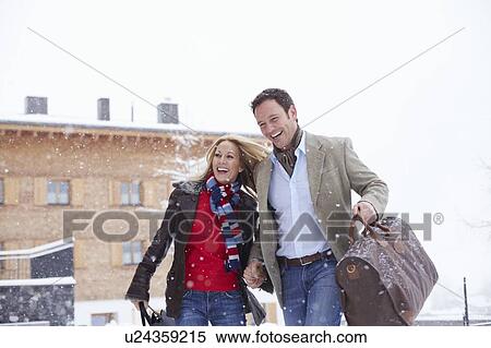 Couple walking together in snow View Large Photo Image Stock Photography - Couple walking together in snow. Fotosearch